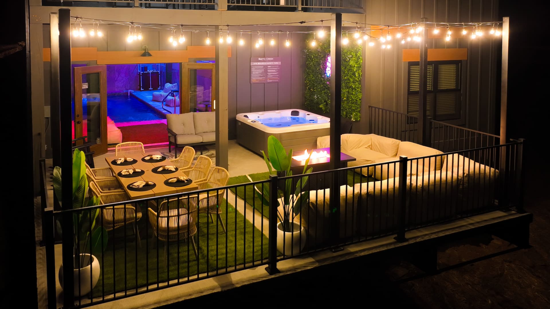 Back Patio with large sectional sofa, hot tub and a dining table