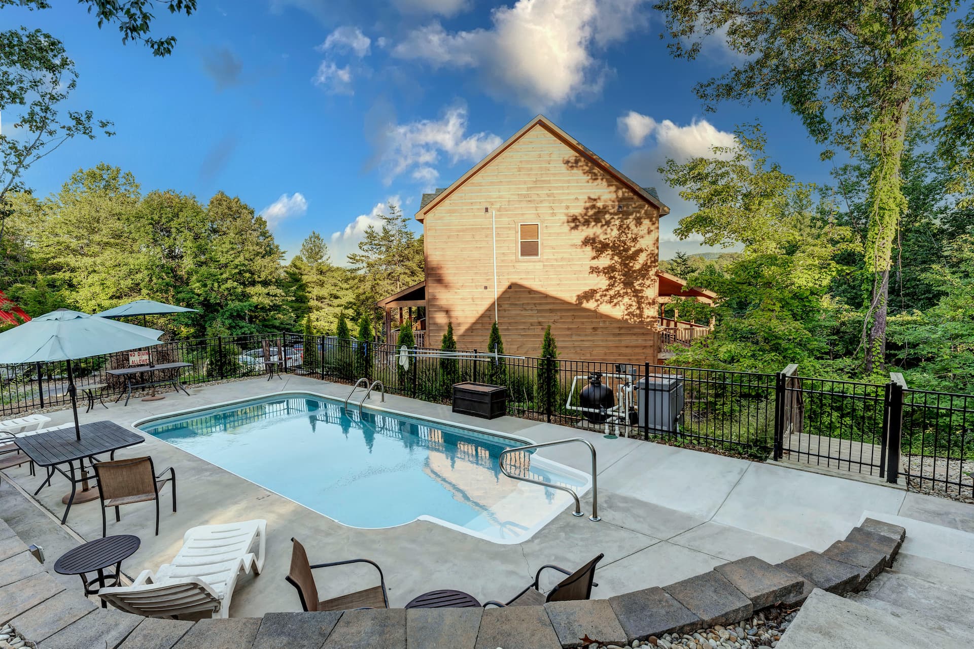 Pool shown at facing the back of a neighboring house